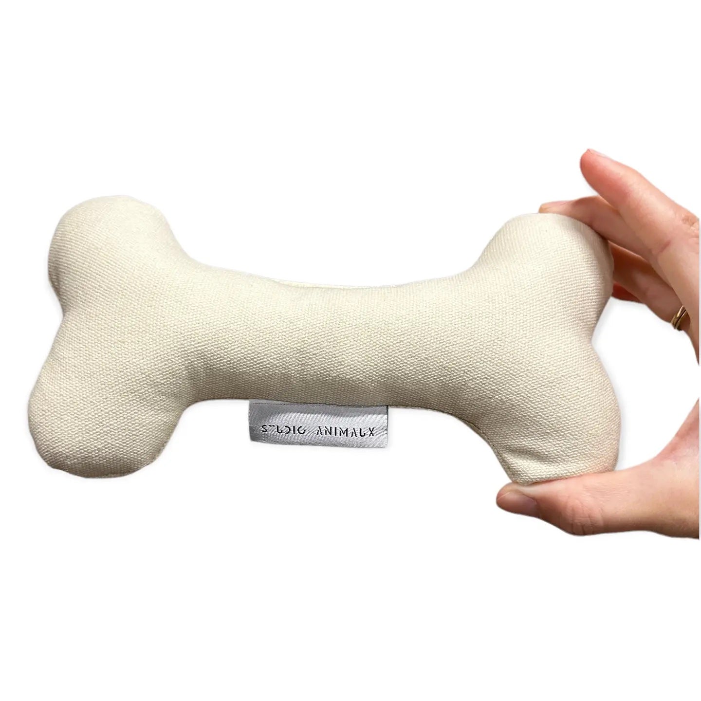 Mjukt hundben i vitt tyg för hundlek och inredning, framsida